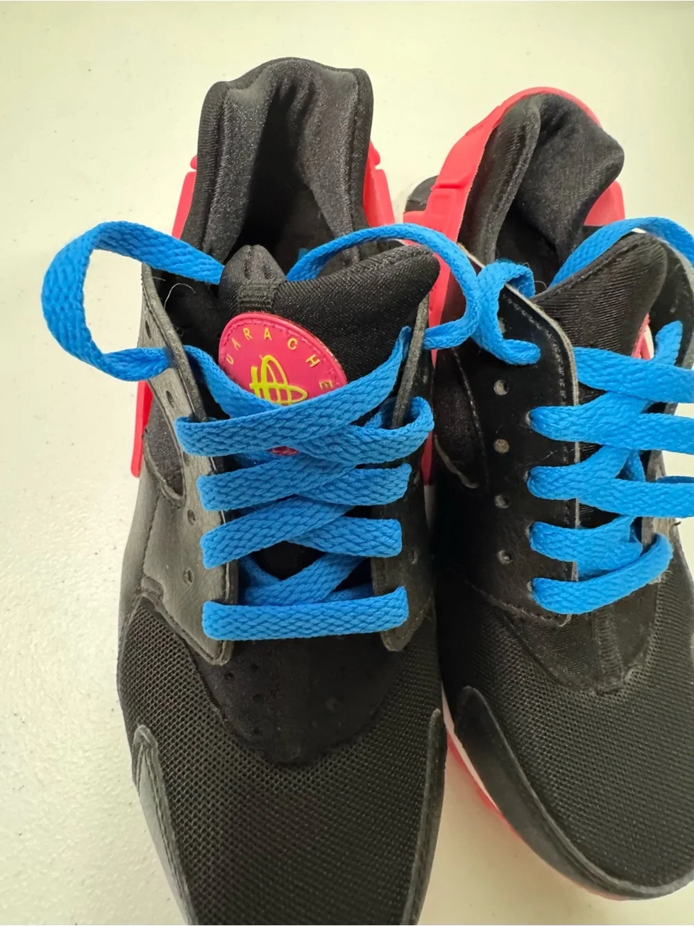 Nike Kids Black Sneakers with Bright Blue Laces and Pink Heel Detail